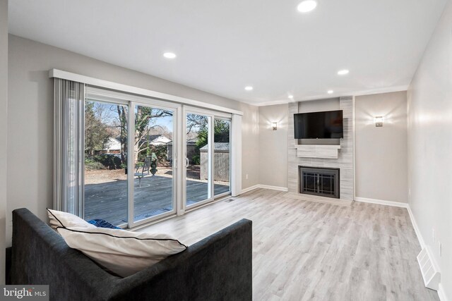 unfurnished living room featuring a fireplace and light hardwood / wood-style floors