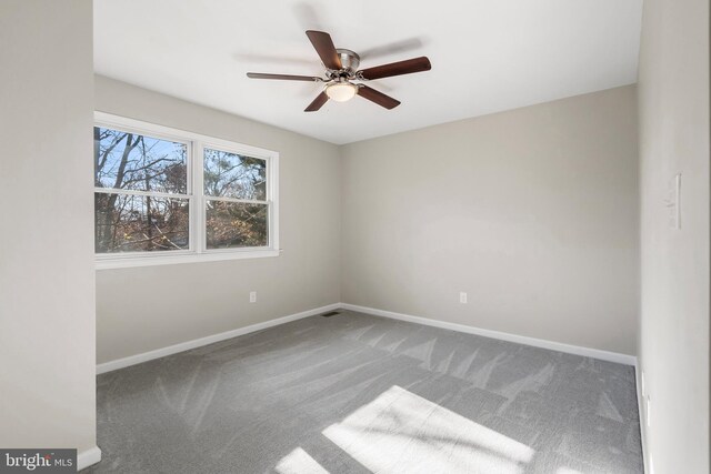 empty room with ceiling fan and carpet