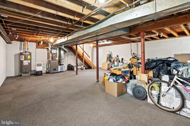 basement featuring electric water heater and heating unit