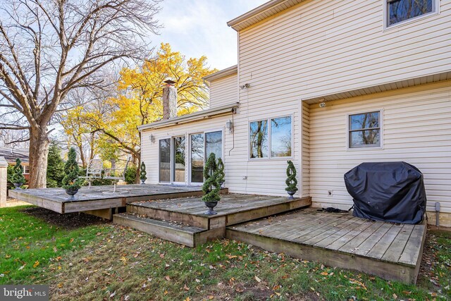 rear view of house featuring a deck