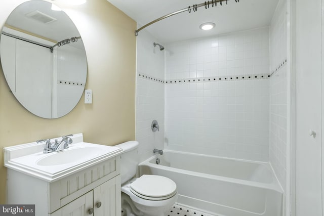 full bathroom featuring tile patterned flooring, vanity, toilet, and tiled shower / bath