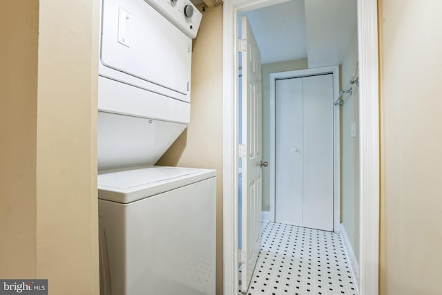 clothes washing area featuring stacked washer / dryer