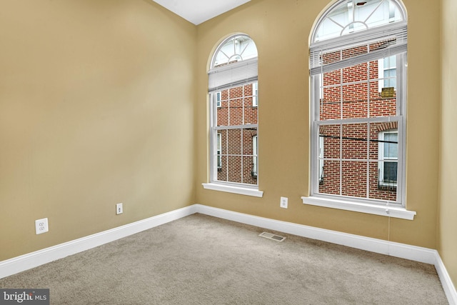 unfurnished room featuring carpet