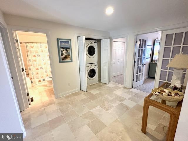 laundry area featuring stacked washer and clothes dryer