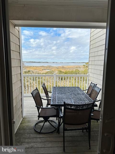 balcony with a water view and a beach view