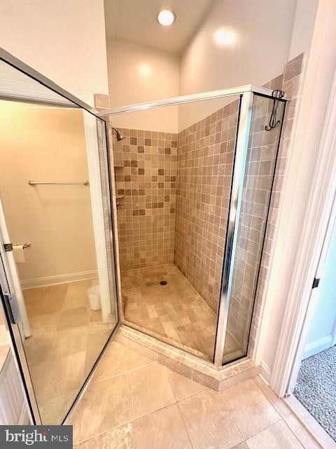 bathroom with tile patterned floors and an enclosed shower