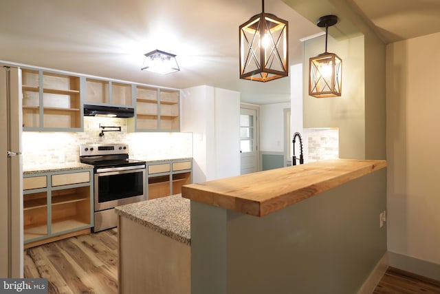 kitchen featuring butcher block countertops, kitchen peninsula, stainless steel electric range oven, and hanging light fixtures