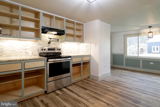 kitchen featuring light stone countertops, backsplash, pendant lighting, light hardwood / wood-style floors, and electric stove