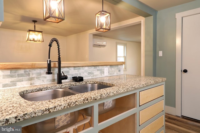 kitchen with a wall mounted AC, decorative backsplash, pendant lighting, and dark hardwood / wood-style floors