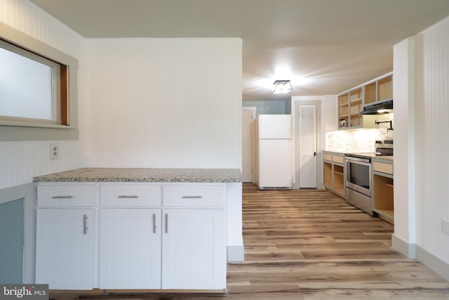 kitchen with electric stove, white cabinetry, light stone counters, and white refrigerator