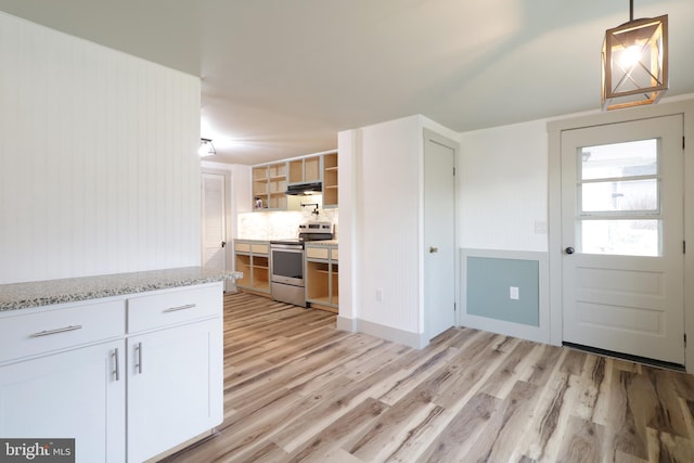 kitchen featuring light stone countertops, decorative light fixtures, light hardwood / wood-style floors, white cabinetry, and stainless steel electric range