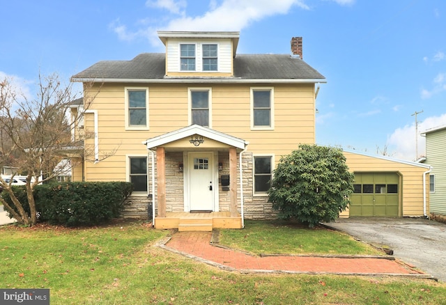 view of front of property featuring a garage and a front yard