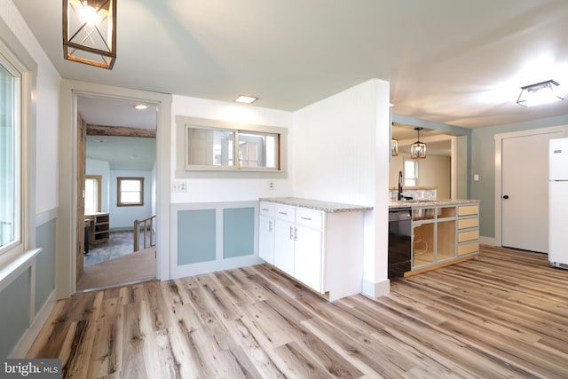 kitchen with white refrigerator, light hardwood / wood-style flooring, dishwasher, white cabinets, and hanging light fixtures