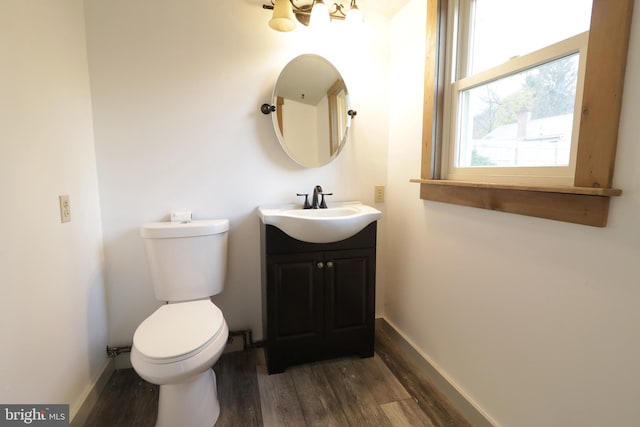 bathroom with vanity, toilet, and wood-type flooring