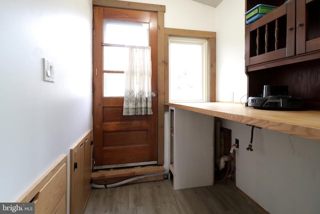 doorway featuring dark hardwood / wood-style flooring and built in desk