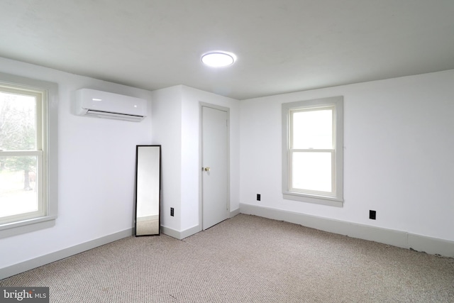 carpeted empty room featuring a wall mounted air conditioner and plenty of natural light