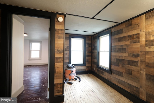 home office featuring hardwood / wood-style floors and wood walls