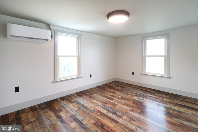 empty room with dark hardwood / wood-style floors and an AC wall unit