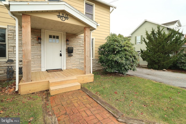 doorway to property with a yard