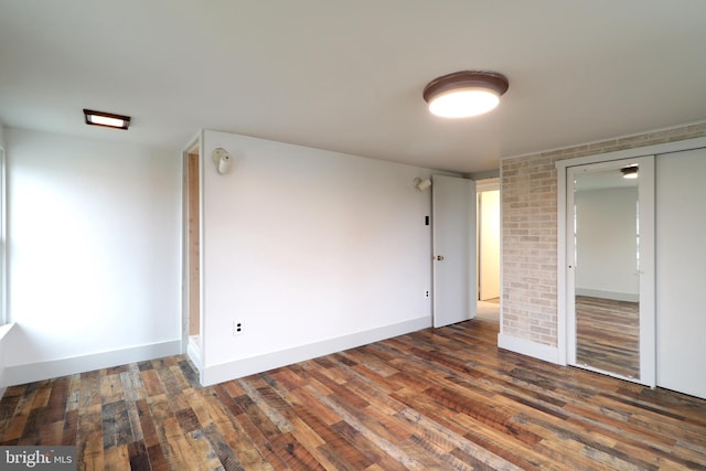 unfurnished room with dark hardwood / wood-style flooring