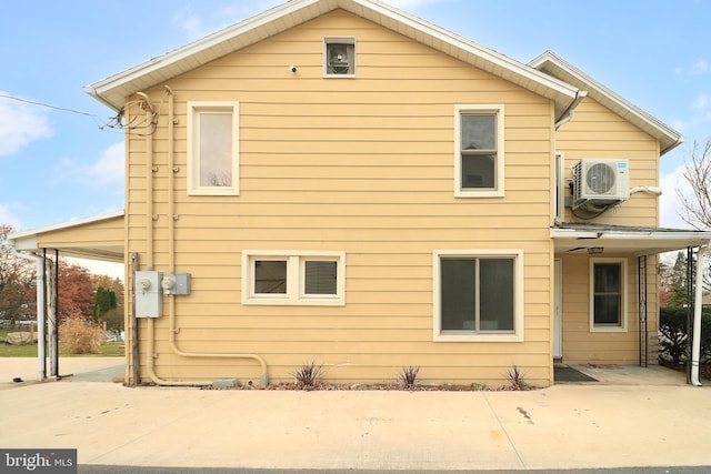 rear view of property with ac unit