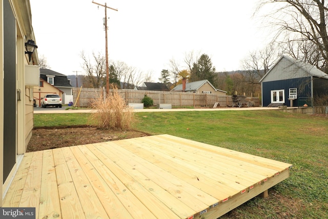 wooden deck featuring a yard