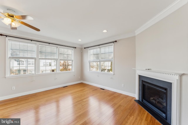 unfurnished living room with light hardwood / wood-style flooring, ceiling fan, and ornamental molding