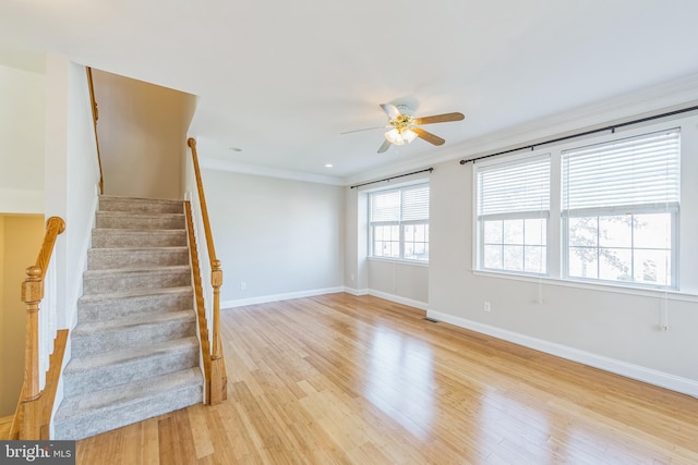 empty room with ceiling fan, light hardwood / wood-style floors, and ornamental molding