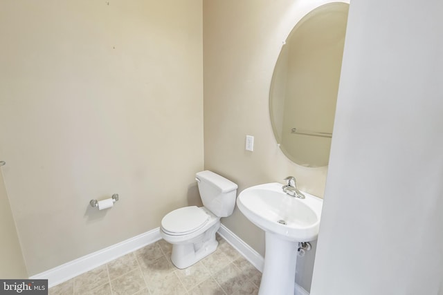 bathroom featuring tile patterned flooring and toilet