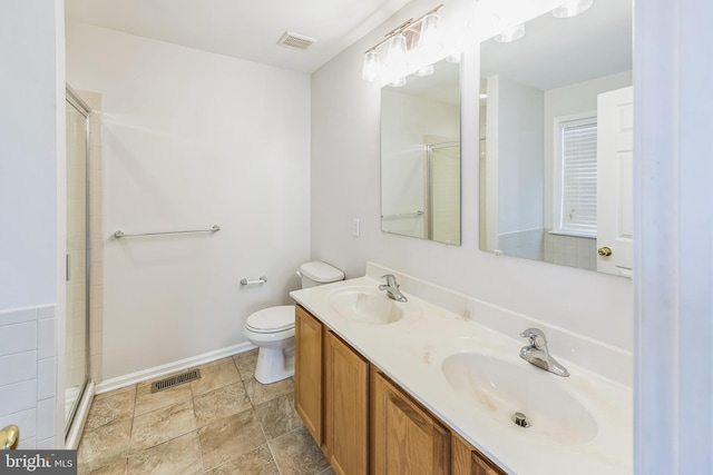 bathroom with vanity, toilet, and an enclosed shower