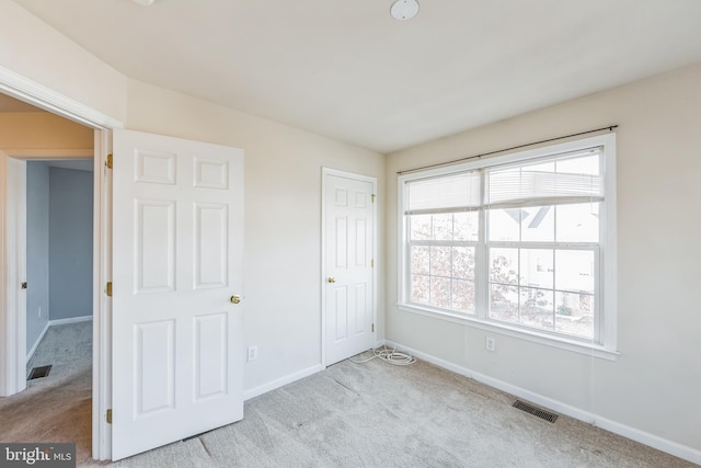 unfurnished bedroom with light carpet