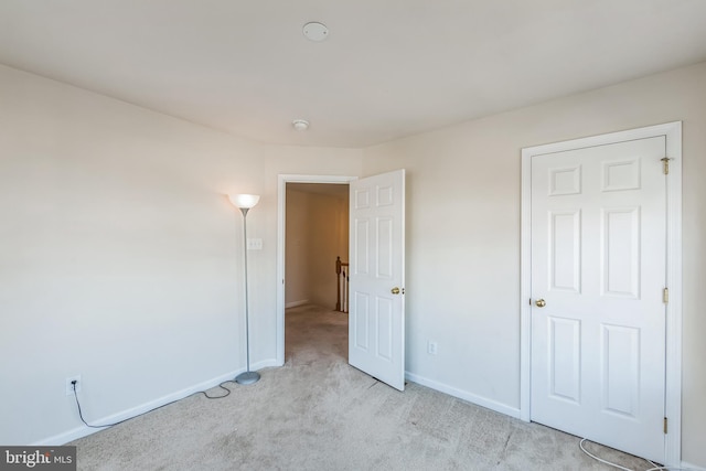 unfurnished bedroom with light carpet