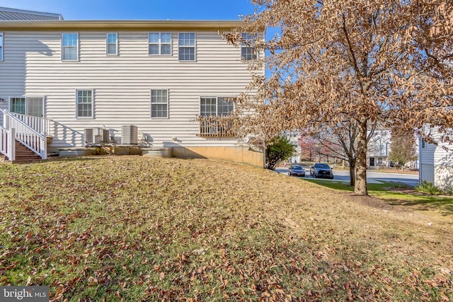 rear view of property with a yard