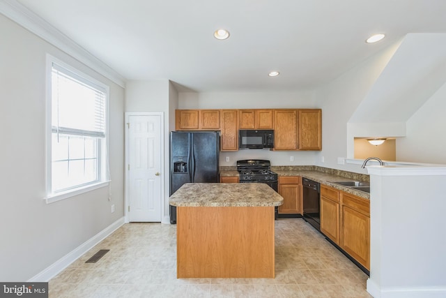 kitchen featuring kitchen peninsula, sink, a center island, and black appliances