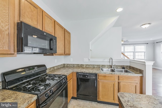 kitchen with light wood-type flooring, sink, ceiling fan, and black appliances