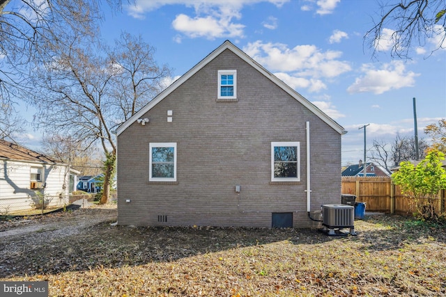 view of side of home with central AC unit