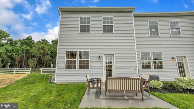 back of house with an outdoor hangout area, a patio area, and a lawn