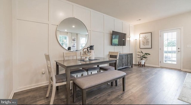 dining area with dark hardwood / wood-style flooring