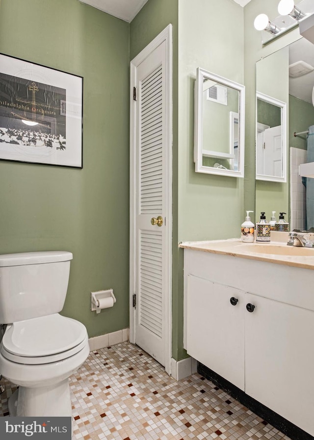 bathroom featuring toilet, vanity, and tile patterned floors