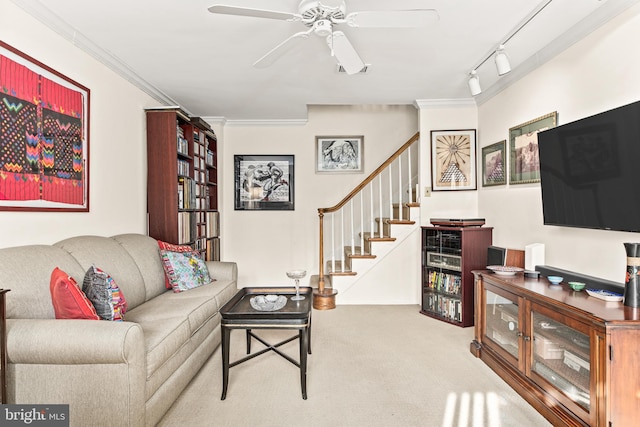 carpeted living room with rail lighting, ceiling fan, and crown molding