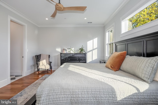 bedroom with ceiling fan, wood-type flooring, and crown molding