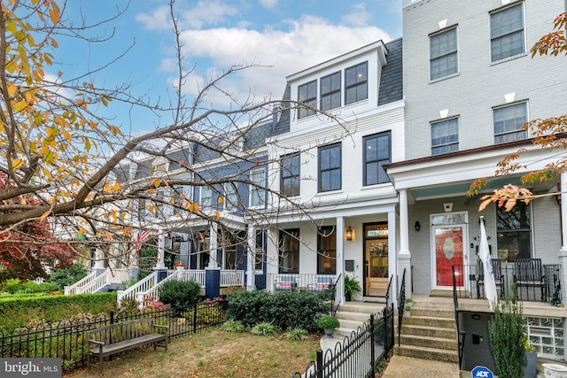 townhome / multi-family property with a porch