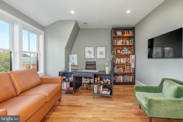 interior space featuring light hardwood / wood-style floors and vaulted ceiling