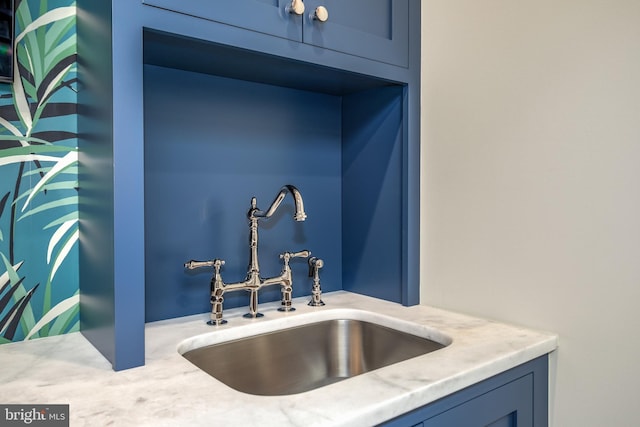 details with blue cabinets and sink