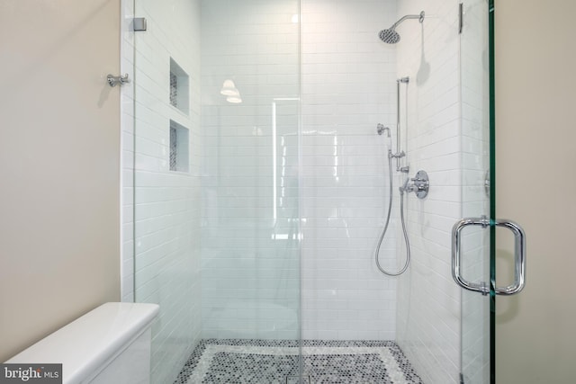 bathroom with a shower with door