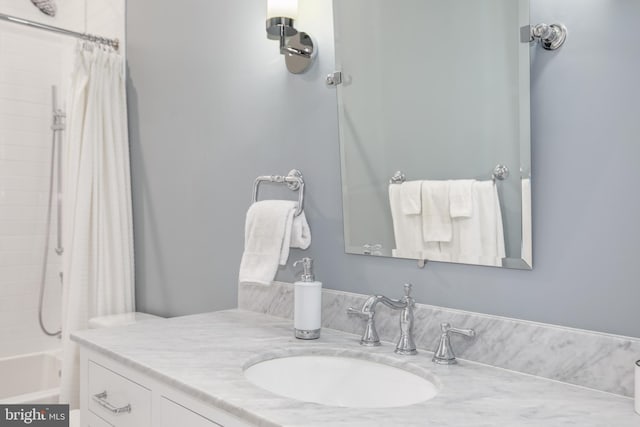 bathroom with shower / bath combo and vanity