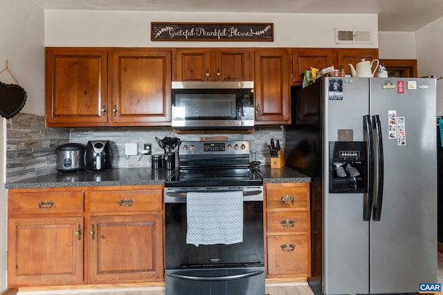 kitchen with backsplash and stainless steel appliances