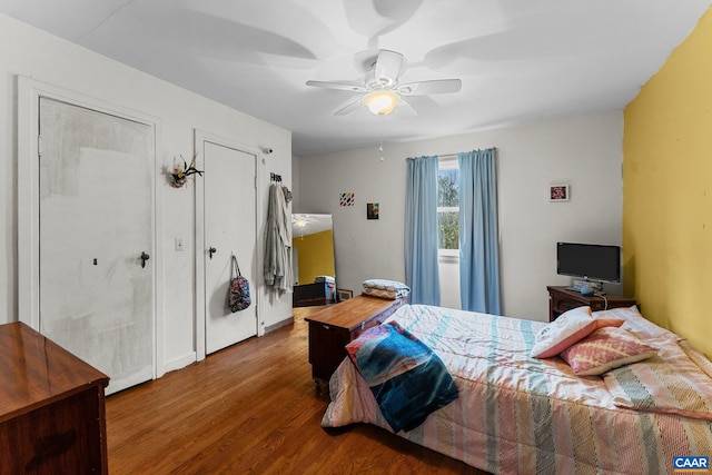 bedroom with ceiling fan and wood-type flooring