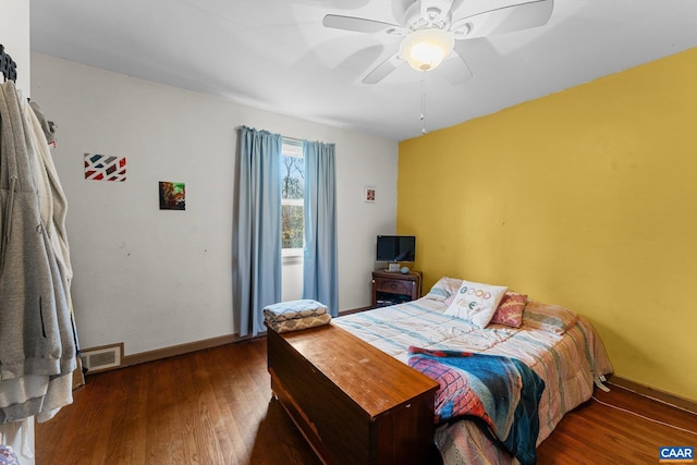 bedroom with ceiling fan and dark hardwood / wood-style flooring