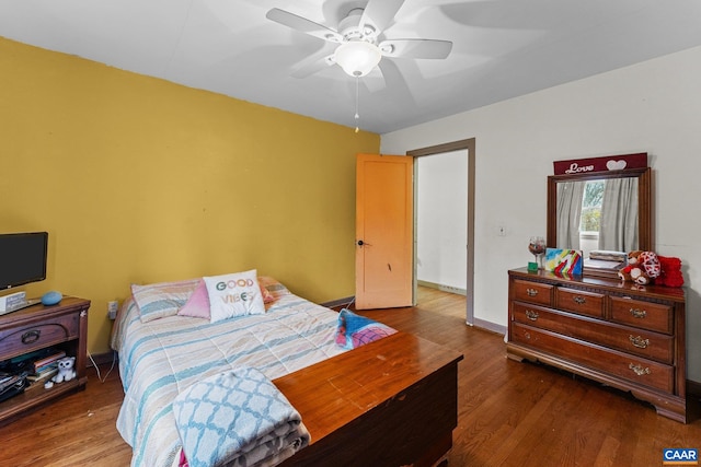 bedroom with ceiling fan and dark hardwood / wood-style flooring